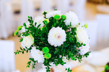 Close-up of a delicate bouquet of white flowers and green twigs