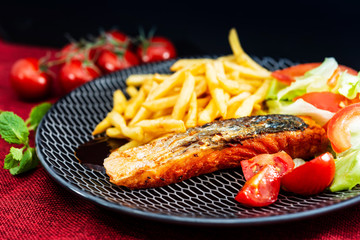 Grilled Salmon with fresh lettuce and Golden French fries