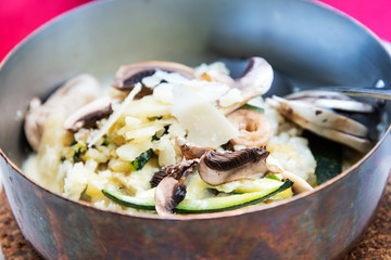 Tasty risotto fresh herbs vegetables on a white plate