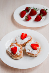 cottage cheese pancakes with strawberry on white table background. Breakfast or Lunch Concept. Top view