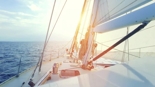 Sailing yacht off shore with beautiful sunset. 4k Video.