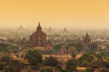 Beautiful sunrise at pagodas of Bagan in misty morning, Myanmar. Bagan is the famous travel and landscape scene of ancient temples.