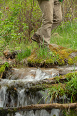 hiking over stream with waterfall