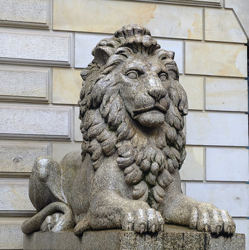Ancient Sculpture of sitting Cairo Kasr El Nile stone Lion in front of pattern backgrounds, stone strong statue, leadership symbol
