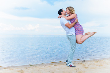 Happy smiling couple, plus size woman at sea outdoors, xl woman on nature, rest and joy the life, man take in hands a lady
 