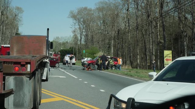 Car accident with first responders on the scene putting someone on a stretcher.