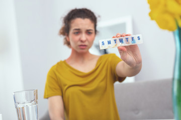 Pill week. Adolescent woman looking unhappy having receiced a full week course of medication