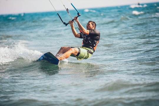 Kitesurfing Kiteboarding action photos man among waves quickly goes