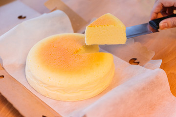 Japanese Cheesecake with seperated slice in opened paper box. Soft and sweet.