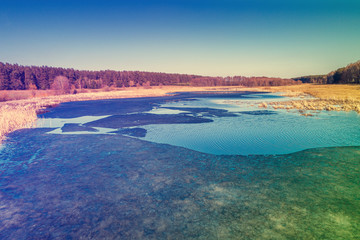 Aerial view of valley with river in early spring. Rural landscape. Wild nature. Gradient artistic color