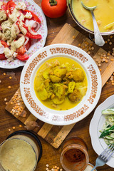 Hot  delicious peas creamy lentil soup puree with new backed potatoes with olive oil, turmeric powder, spices and herbs. Mixed with blender. Raw vegan vegetarian healthy food on lunch or dinner