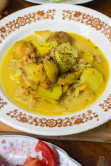 Hot  delicious peas creamy lentil soup puree with new backed potatoes with olive oil, turmeric powder, spices and herbs. Mixed with blender. Raw vegan vegetarian healthy food on lunch or dinner