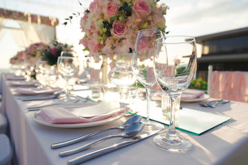 Dinner table with flower decoration in Wedding ceremony in the sunset time.