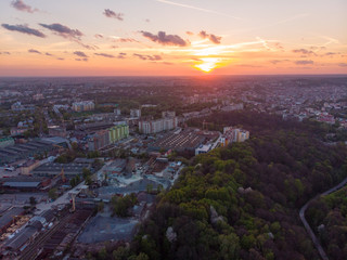 orange sunset above city. aerial view. tree crowns