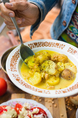 Hot  delicious peas creamy lentil soup puree with new backed potatoes with olive oil, turmeric powder, spices and herbs. Mixed with blender. Raw vegan vegetarian healthy food on lunch or dinner