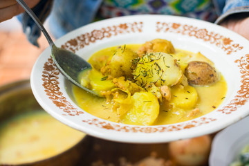 Hot  delicious peas creamy lentil soup puree with new backed potatoes with olive oil, turmeric powder, spices and herbs. Mixed with blender. Raw vegan vegetarian healthy food on lunch or dinner