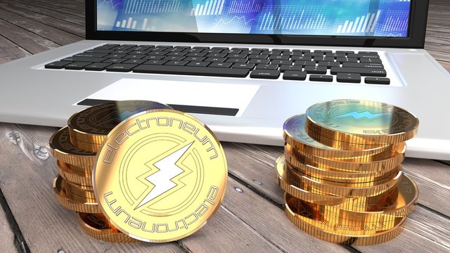 Electroneum coin, close up macro wide shot of digital coins and a laptop computer