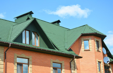 Metal roof house construction with attic, rain gutter and roofing problem area.