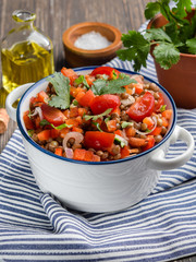 Fresh healthy salad with tomatoes, lentils, onions, summer homemade dish. Vertical.