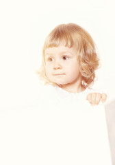 Portrait of a cute little girl in a white dress on white background