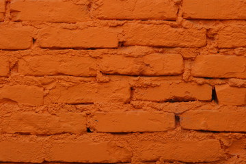 Old brick wall painted in orange color