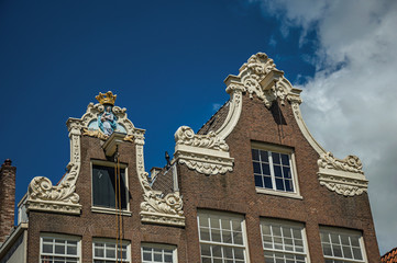 Close-up of brick house facade decoration at Begijnhof, a medieval semi-monastic community in Amsterdam. Famous for its huge cultural activity, graceful canals and bridges. Northern Netherlands.
