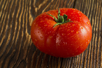 Close-up of fresh, ripe tomatoes on wood background