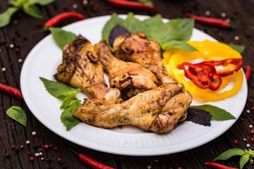 Roasted chicken quarter legs on rustic background