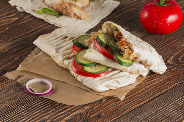 Fast food. Eastern food. Shish kebab, lyulya-kebab, shaverma, pita gyros, shawarma. Street food. Shaurma is on the wooden table