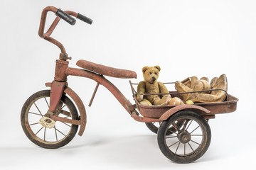 Fototapeta na wymiar Nostalgic vintage toys including straw teddy bear