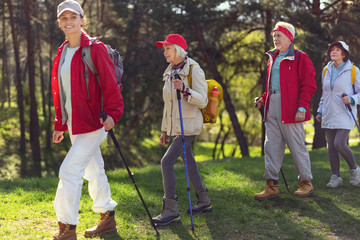 We love walking. Pretty alert guide smiling and her hikers following her one by one