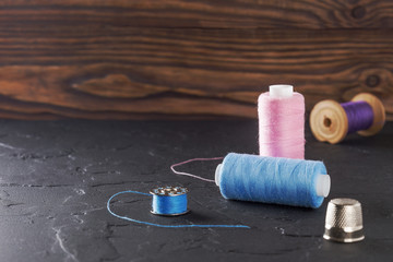 sewing thread on bobbins of blue and pink color