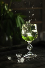 mint lemonade in a transparent glass  (fresh petals of mint in the cooled drink)