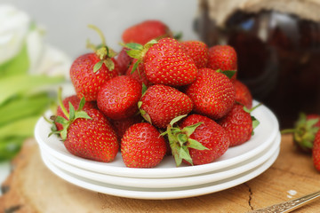 Strawberry Jam and Fresh Strawberries Textured Cement Gray Background and Jam Jar