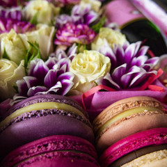 bright composition of macaroni, flowers and a bottle of wine