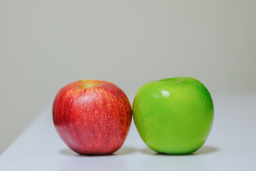 Close up of fresh red and green apple on table.