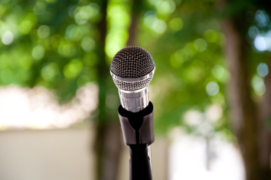 isolated microphone on blurred nature background, outdoor 