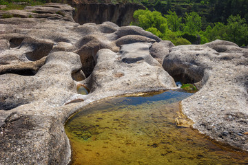 Rocks eroded by the river Tastavins before forming the waterfall of Portellada, Matarrana region, Teruel province, Spain