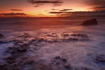 Fototapeta na wymiar Sunset on long beach in Tarragona, Spain