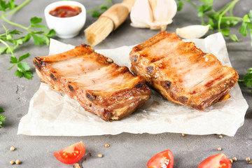 Delicious grilled ribs on table