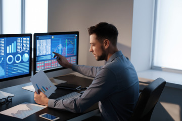 Male broker working in office. Finance trading concept