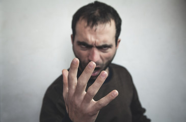 Angry caucasian man shouting and showing hand.