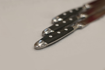 Cutlery. Knives. Close-up. Background of no sharpnes
