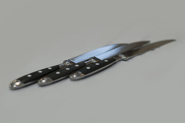 Cutlery. Knives. Close-up. Background of no sharpnes
