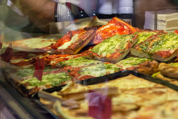 Local bakery selling delicious pizzas and focaccia bread.