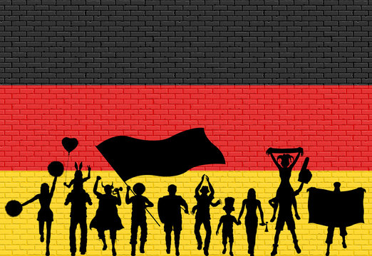 German supporter silhouette in front of brick wall with Germany flag