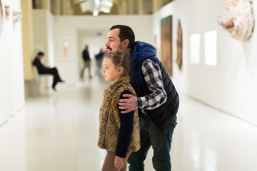 Young man and daughter enjoying expositions