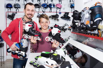 Smiling father and son boasting roller-skates
