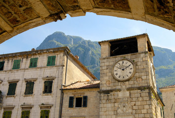 Fototapeta na wymiar Ancient City Hall clock view through city gate. Kotor , Montenegro