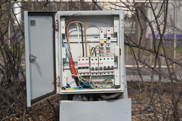 The electrical box contains many terminals, relays, wires and switches. Old outdoor cabinet